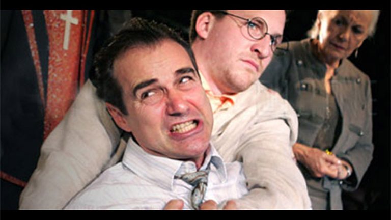 Paul Herzberg being held back by another man