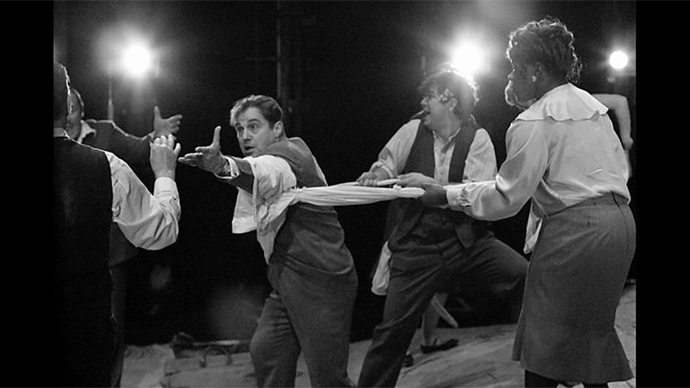 Paul Herzberg being pulled back by a group of people